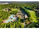 Aerial view of a large community pool, golf course, and clubhouse surrounded by trees at 679 Gold Valley Pass, Canton, GA 30114
