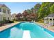 Refreshing swimming pool with a diving board, accompanied by a charming gazebo and beautiful backyard landscaping at 679 Gold Valley Pass, Canton, GA 30114