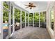 Inviting screened porch with stone flooring and ceiling fan, perfect for outdoor relaxation and entertaining at 679 Gold Valley Pass, Canton, GA 30114