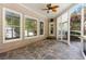 Relaxing screened porch with stone floor, ceiling fan, and views of the beautiful backyard and swimming pool at 679 Gold Valley Pass, Canton, GA 30114