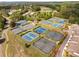 An aerial view of the community tennis courts with lush landscaping and surrounding neighborhood at 679 Gold Valley Pass, Canton, GA 30114