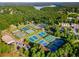 Aerial view of well-maintained tennis courts surrounded by lush greenery in a residential community at 679 Gold Valley Pass, Canton, GA 30114