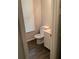 Cozy bathroom with a toilet, cabinet and window at 985 Romer Pl, Stone Mountain, GA 30083