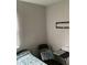 Bedroom featuring a gray accent wall, complemented by simple furnishing at 985 Romer Pl, Stone Mountain, GA 30083