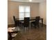 Dining room featuring hardwood floors, classic black chairs, and natural light at 985 Romer Pl, Stone Mountain, GA 30083