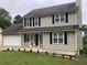 Two-story home with well-maintained lawn, attached garage, and classic curb appeal at 985 Romer Pl, Stone Mountain, GA 30083