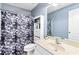 Bathroom featuring a single sink, toilet and a shower with a black and white curtain at 1114 Ivey Chase Pl, Dacula, GA 30019