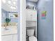 Charming powder room with cabinet, toilet and stylish wall decor at 1114 Ivey Chase Pl, Dacula, GA 30019