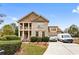 Charming two-story home with brick and siding, columns, landscaped yard, and a paved driveway at 1114 Ivey Chase Pl, Dacula, GA 30019