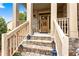 Inviting front porch with brick stairs and decorative lanterns leading to a wood front door at 1114 Ivey Chase Pl, Dacula, GA 30019
