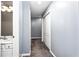 Bright hallway with neutral carpet and a view of the bathroom sink at 1114 Ivey Chase Pl, Dacula, GA 30019
