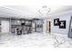 Open kitchen with gray cabinets, tile floors and backsplash, granite countertops, and stainless steel appliances at 1114 Ivey Chase Pl, Dacula, GA 30019