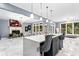 Spacious kitchen with a large island, pendant lighting, marble floors, and view of the living room at 1114 Ivey Chase Pl, Dacula, GA 30019
