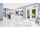 Open living area with tile floors, kitchen, dining area and French doors leading to outdoor seating at 1114 Ivey Chase Pl, Dacula, GA 30019