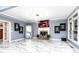 Spacious living room features tile floors, fireplace, modern lighting, large windows, and unique artwork at 1114 Ivey Chase Pl, Dacula, GA 30019