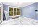 Bright living room with large window, tile floors, modern lighting and bench seat at 1114 Ivey Chase Pl, Dacula, GA 30019