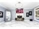 Large living room features modern light fixture, tile floors, fireplace, and unique artwork at 1114 Ivey Chase Pl, Dacula, GA 30019