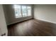 Bedroom featuring hardwood floors, three windows, and neutral decor at 128 Bert Lane Se # 167, Atlanta, GA 30316