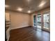 Open living space with hardwood floors, large windows, and access to a balcony at 128 Bert Lane Se # 167, Atlanta, GA 30316