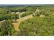 Lush aerial view showcases the lot on a verdant, tree-lined street in a quiet residential neighborhood at 1724 Arbor Hill Rd, Canton, GA 30115