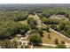 Expansive aerial perspective of a wooded community highlighting a property with long drive and mature trees at 1724 Arbor Hill Rd, Canton, GA 30115