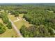 Wide angle aerial shot of home with manicured lawn and surrounding trees and neighboring homes at 1724 Arbor Hill Rd, Canton, GA 30115