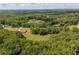Wooded community aerial view featuring a well-maintained home surrounded by mature trees and vegetation at 1724 Arbor Hill Rd, Canton, GA 30115