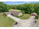 Aerial view of a well-maintained ranch-style house with detached garage and long, elegant driveway at 1724 Arbor Hill Rd, Canton, GA 30115