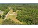 Expansive aerial view of land featuring a house with an extensive yard and driveway surrounded by lush greenery at 1724 Arbor Hill Rd, Canton, GA 30115