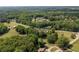Wide aerial shot of a home nestled among lush trees, showcasing its setting within a wooded area at 1724 Arbor Hill Rd, Canton, GA 30115