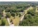Extensive aerial view of a wooded community, showcasing a property with a pool and long drive at 1724 Arbor Hill Rd, Canton, GA 30115