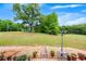 Lush backyard with a gravel walkway, mature trees, and peaceful ambiance at 1724 Arbor Hill Rd, Canton, GA 30115