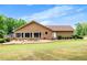 Back view of brick home featuring a large backyard and multiple points of access at 1724 Arbor Hill Rd, Canton, GA 30115