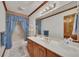 Well-lit bathroom featuring single sink vanity, bathtub, and storage at 1724 Arbor Hill Rd, Canton, GA 30115