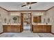 Bathroom featuring double vanity sinks, decorative mirrors, and access to main bedroom at 1724 Arbor Hill Rd, Canton, GA 30115