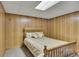 Finished bedroom with wood paneled walls and plush carpet, offering a comfortable retreat at 1724 Arbor Hill Rd, Canton, GA 30115