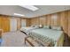 Finished bedroom showcases wood paneled walls, neutral carpet and two closets at 1724 Arbor Hill Rd, Canton, GA 30115