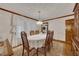 Traditional dining room with wood trim, chandelier, and formal dining set for six at 1724 Arbor Hill Rd, Canton, GA 30115