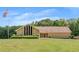 Spacious ranch-style home with manicured lawn, lush landscaping, and an American flag waving in front at 1724 Arbor Hill Rd, Canton, GA 30115