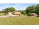 Exterior shot showcasing well-maintained home, two-car garage, outbuilding, landscaping, and long driveway at 1724 Arbor Hill Rd, Canton, GA 30115