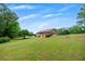 Sprawling backyard showcasing the back of the home with an outdoor deck at 1724 Arbor Hill Rd, Canton, GA 30115