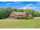 Expansive lawn surrounds a ranch-style house featuring a back patio and meticulously kept landscaping around the perimeter at 1724 Arbor Hill Rd, Canton, GA 30115