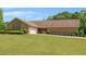 Ranch-style home boasting an attached garage, a pristine lawn, and sculpted shrubbery lining the walkway at 1724 Arbor Hill Rd, Canton, GA 30115