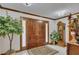 Elegant foyer features double wood doors, a decorative rug, tile flooring, and classic wooden accents and details at 1724 Arbor Hill Rd, Canton, GA 30115
