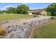 Exterior of home showcasing long driveway leading up to two-car garage and surrounding landscaped yard at 1724 Arbor Hill Rd, Canton, GA 30115