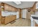 Spacious kitchen boasts wood cabinets, white appliances, and linoleum flooring at 1724 Arbor Hill Rd, Canton, GA 30115