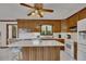 Well-lit kitchen featuring a center island, ample counter space, and modern white appliances at 1724 Arbor Hill Rd, Canton, GA 30115