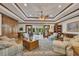 Bright living room featuring coffered ceilings, hardwood floors, custom built-ins, and a seamless transition to sunroom at 1724 Arbor Hill Rd, Canton, GA 30115