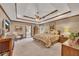 Spacious main bedroom featuring a tray ceiling, ceiling fan, and ensuite bathroom entrance at 1724 Arbor Hill Rd, Canton, GA 30115