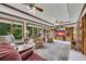 Bright sun room with multiple armchairs and a view of the well-maintained lawn at 1724 Arbor Hill Rd, Canton, GA 30115